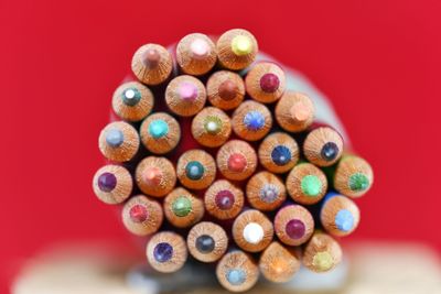 Close-up of colored pencils against red background