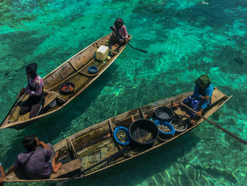 High angle view of people sitting on boat in sea