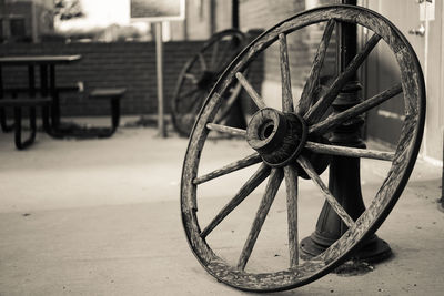 Close-up of old wagon wheel on street