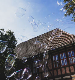 Low angle view of bubbles against sky