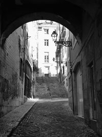 Empty alley amidst buildings in city