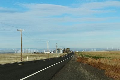 Road by sea against sky