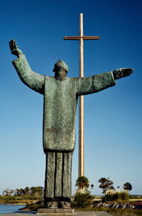 Low angle view of statue against blue sky