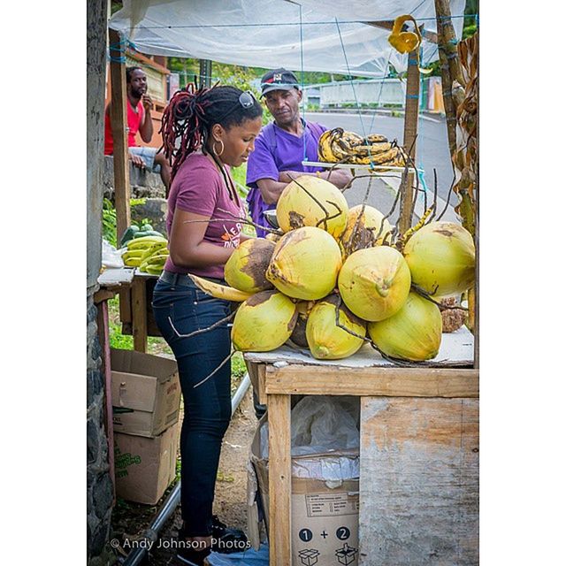 fruit, food and drink, men, transfer print, architecture, built structure, food, lifestyles, healthy eating, rear view, standing, day, retail, indoors, leisure activity, casual clothing, building exterior, auto post production filter