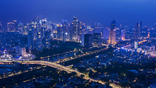 High angle view of illuminated buildings in city at night