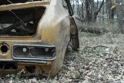 Abandoned car on field