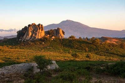 Rock formations on landscape against sky