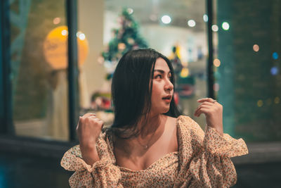 Portrait of young woman looking away outdoors