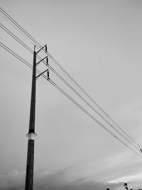 Low angle view of telephone pole against sky