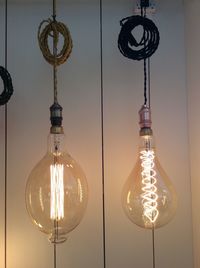 Low angle view of illuminated light bulbs