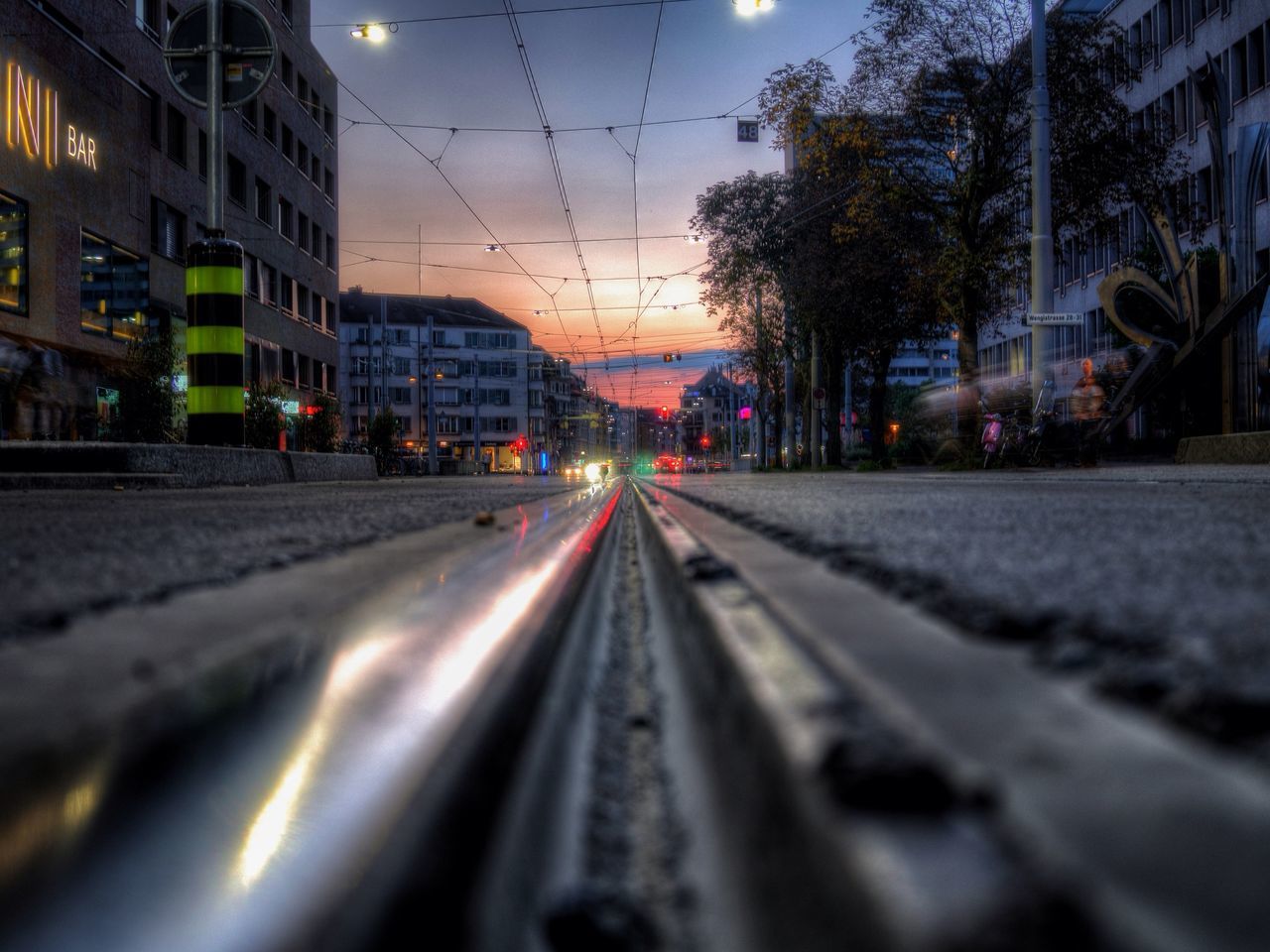 transportation, railroad track, the way forward, surface level, diminishing perspective, rail transportation, vanishing point, building exterior, built structure, sky, architecture, road, street, public transportation, outdoors, city, mode of transport, long, no people, selective focus
