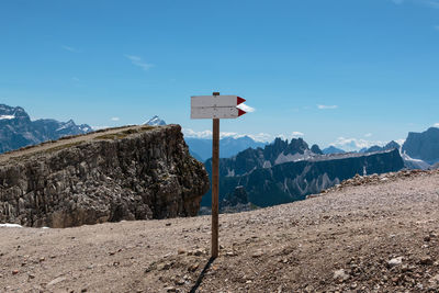 View of sign on mountain against blue sky