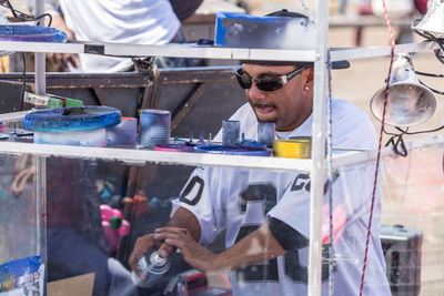 Portrait of man working in glass