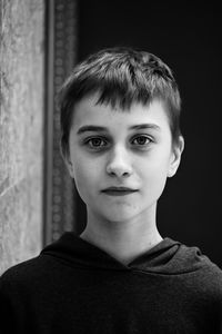 Portrait of boy against black background