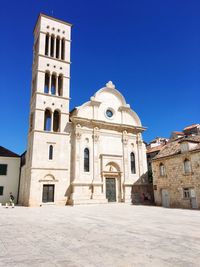 Low angle view of historic building against clear blue sky