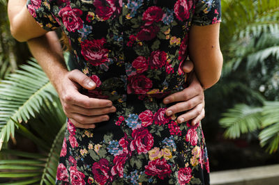 Midsection of woman holding flower bouquet