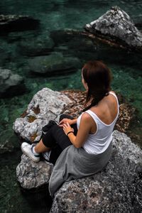 Woman sitting on rock