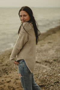 Young woman standing at beach