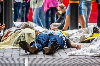 High angle view of people sitting on bed