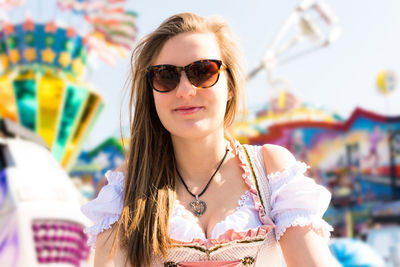 Young woman wearing sunglasses at amusement park