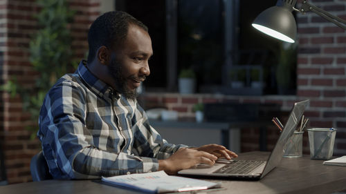 Young man using laptop at table