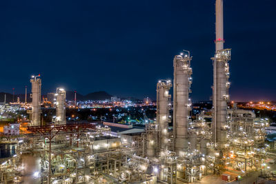 High angle view of illuminated buildings against sky at night