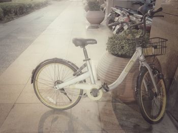 Bicycle parked on sidewalk in city