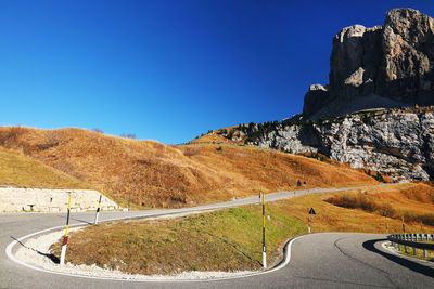 Road by mountain against clear sky