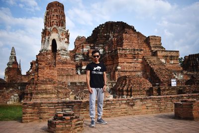 Full length of man standing outside historic building