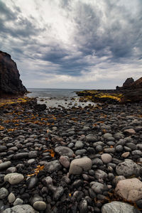 Rocks on beach against sky