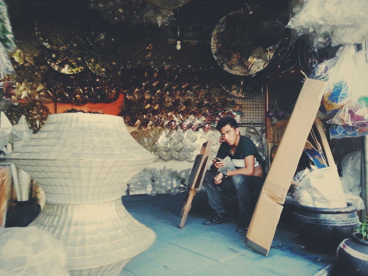 lifestyles, leisure activity, casual clothing, men, holding, young adult, indoors, person, full length, sitting, arts culture and entertainment, enjoyment, standing, young women, togetherness, built structure