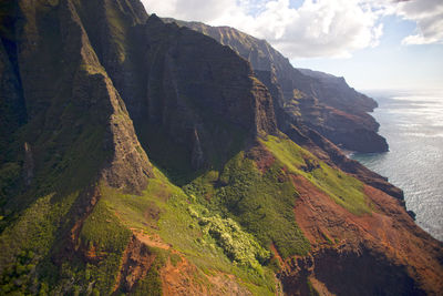 Scenic view of sea and mountains against sky