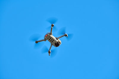 Quadcopter drone in sky. small drone flies in sky takes video and photo. remote control air delivery