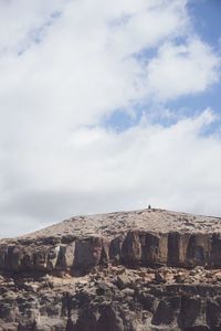 Scenic view of cliff against sky