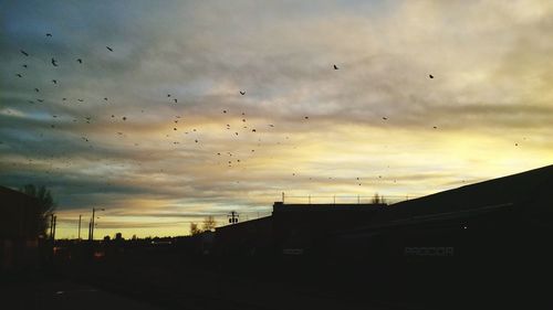 Low angle view of built structure against sky at sunset