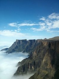 Scenic view of mountains against cloudy sky