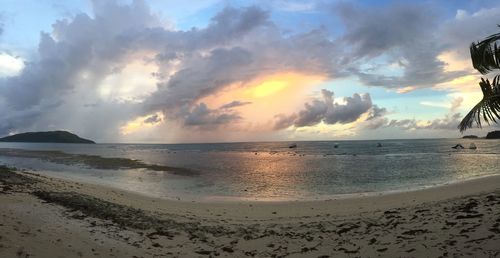 Scenic view of beach against sky during sunset