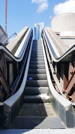 Staircase in city against sky