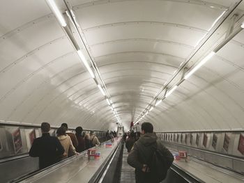 Rear view of people walking in subway station