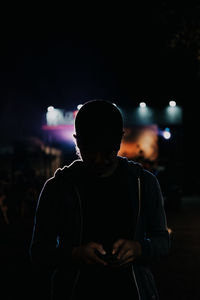 Man using smart phone at night