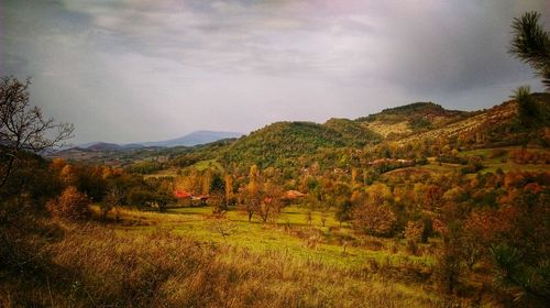 Countryside landscape against mountain range