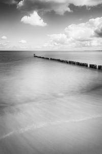 Scenic view of sea against cloudy sky