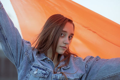 Portrait of woman wearing orange textile outdoors