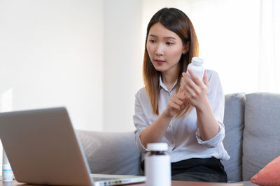 Young woman using laptop at home