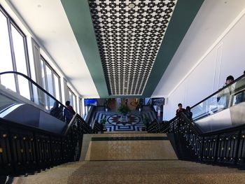 People walking on staircase in modern building
