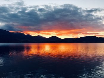 Scenic view of lake against romantic sky at sunset