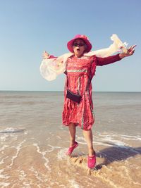 Full length of woman standing on beach