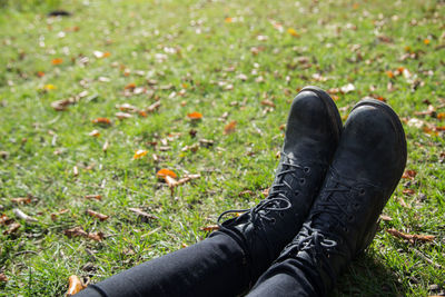 Low section of woman standing on field