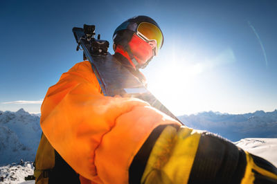 Portrait of a skier against the backdrop of the snow-capped mountains of the caucasus. a man in a