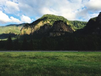 Scenic view of mountains against cloudy sky